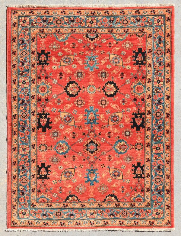 Knotted by hand in Afghanistan with hand-carded, hand-spun, vegetable-dyed wool. A classic Mahal design inspired by the village weaving traditions of western Persia. The spacious drawing features stylized palmettes and geometric floral motifs set within a warm madder-red field, framed by a meandering floral border.