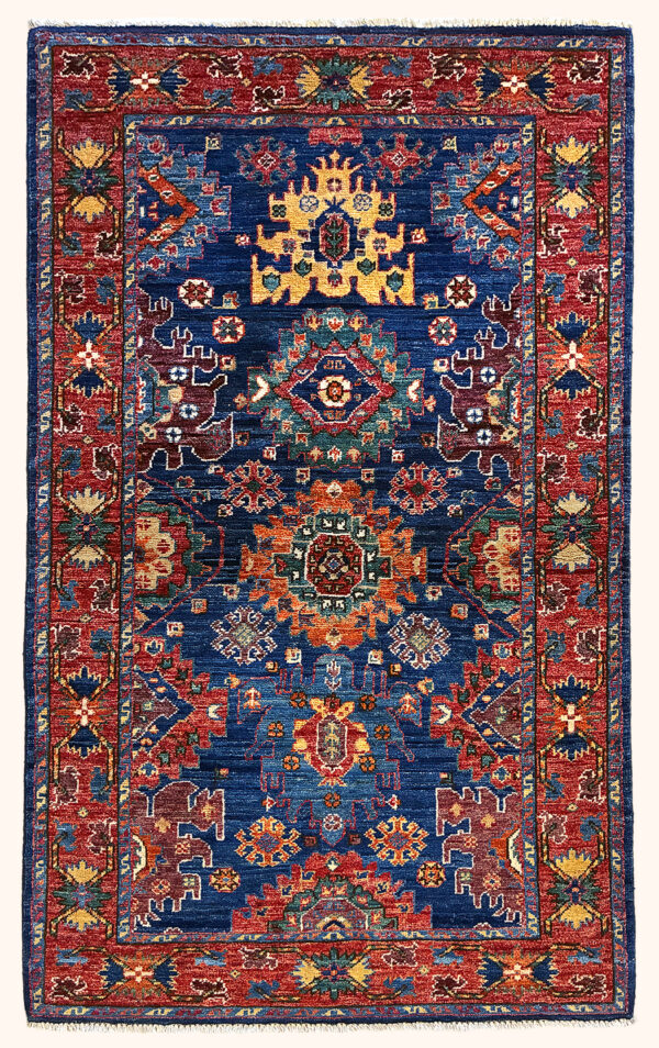Afghan Shirvan rug knotted by hand with hand-spun, vegetable-dyed wool. All-over jewel tone tribal medallions.
